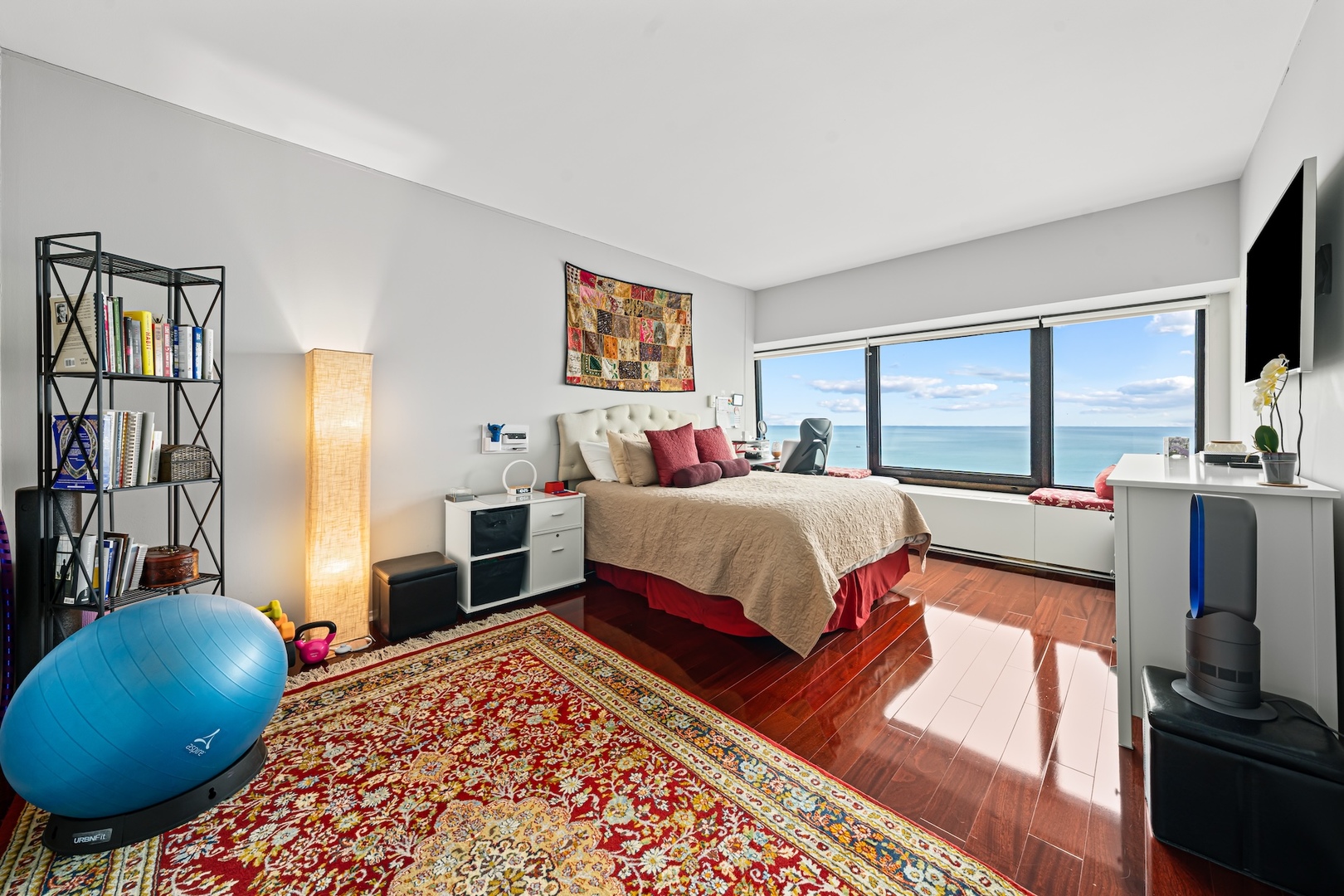 175 East Delaware Place, Unit 6706 Chicago, IL 60611 - Photo 11 of 26 a bedroom with a bed a dresser and a flat screen tv