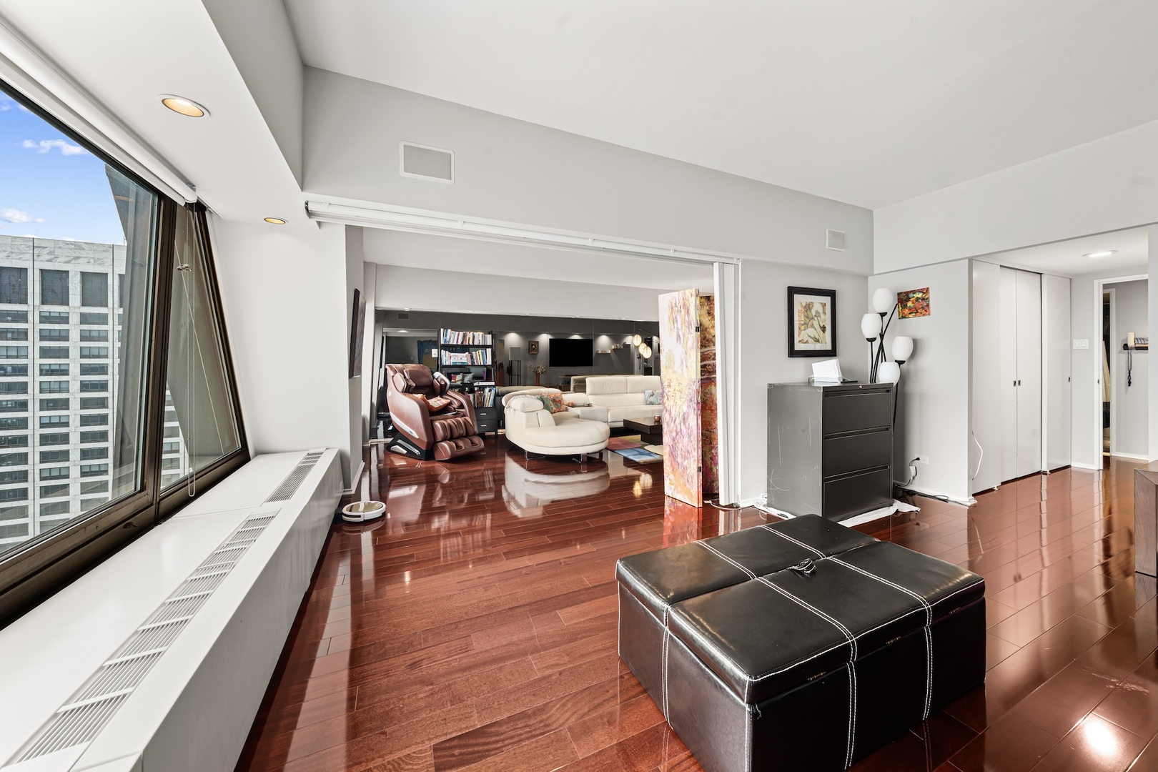 175 East Delaware Place, Unit 6706 Chicago, IL 60611 - Photo 5 of 26 a room with furniture and wooden floor