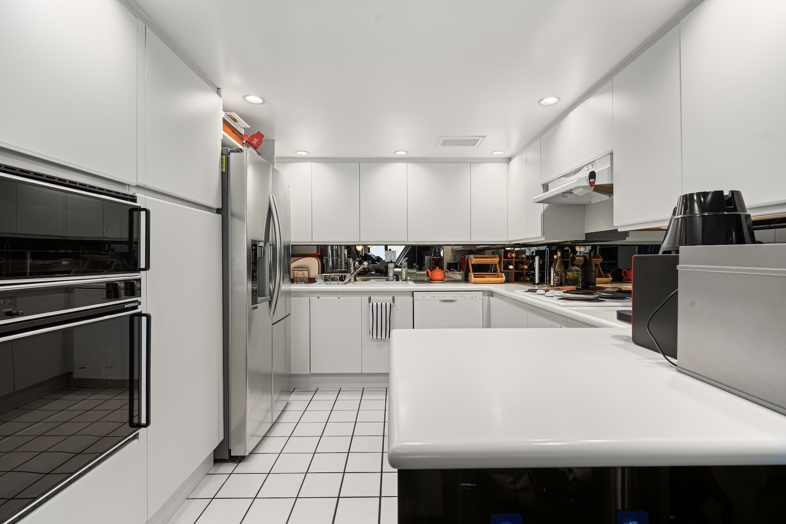 175 East Delaware Place, Unit 6706 Chicago, IL 60611 - Photo 8 of 26 a kitchen with a sink a refrigerator and cabinets