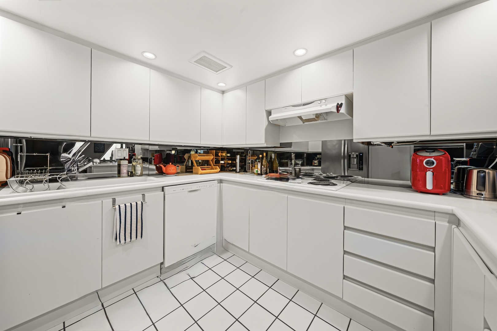 175 East Delaware Place, Unit 6706 Chicago, IL 60611 - Photo 9 of 26 a kitchen with white cabinets a sink and dishwasher