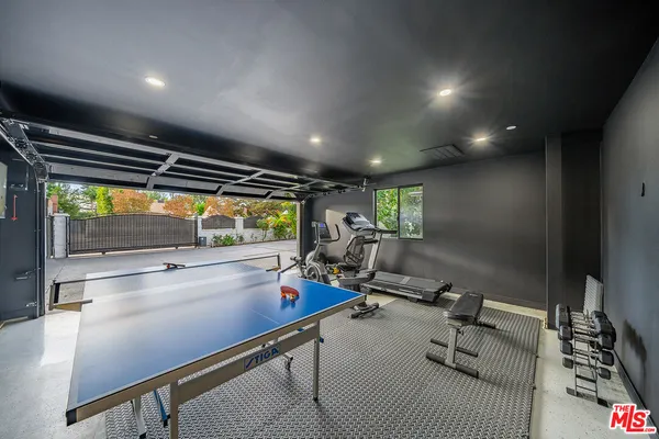 a kitchen with kitchen island stainless steel appliances a sink and counter space