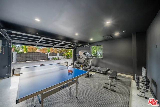 a kitchen with kitchen island stainless steel appliances a sink and counter space