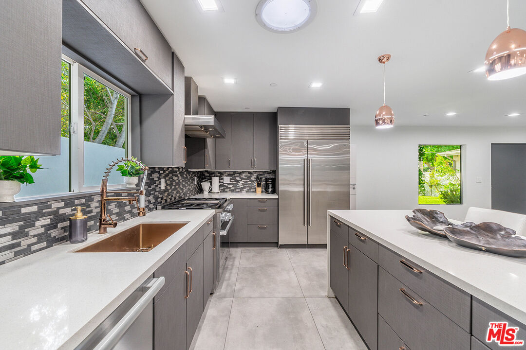 5010 Fulton Avenue Sherman Oaks, CA 91423 - Photo 18 of 55 a kitchen with a sink stove and cabinets
