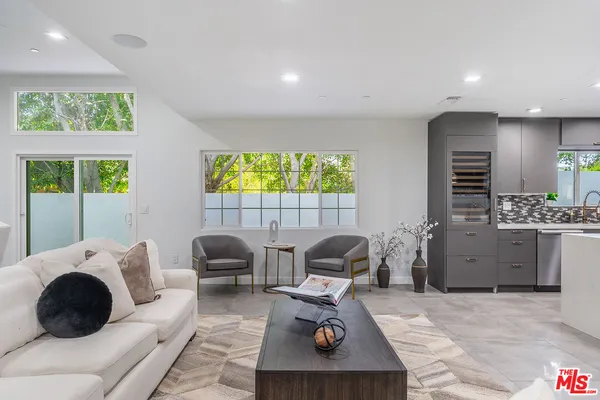 a bathroom with a bathtub shower sink mirror and toilet