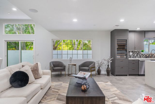 a bathroom with a bathtub shower sink mirror and toilet