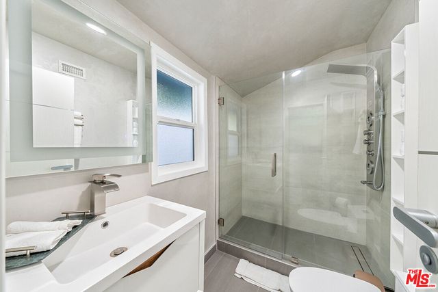 a spacious bedroom with a bed and furniture