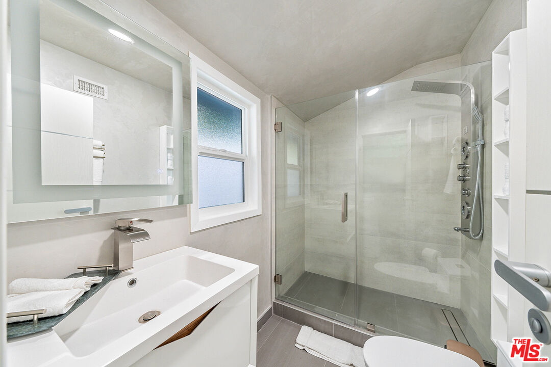 5010 Fulton Avenue Sherman Oaks, CA 91423 - Photo 28 of 55 a bathroom with a bathtub shower sink mirror and toilet