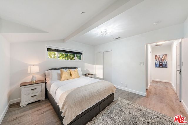 a bedroom with a bed and a chair