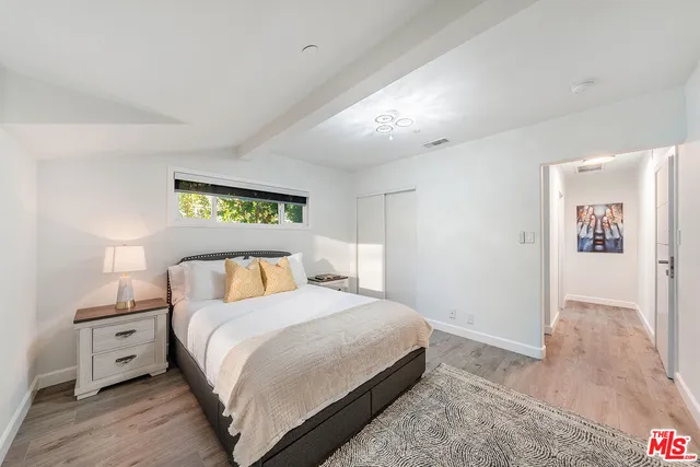 a bedroom with a bed and a chair