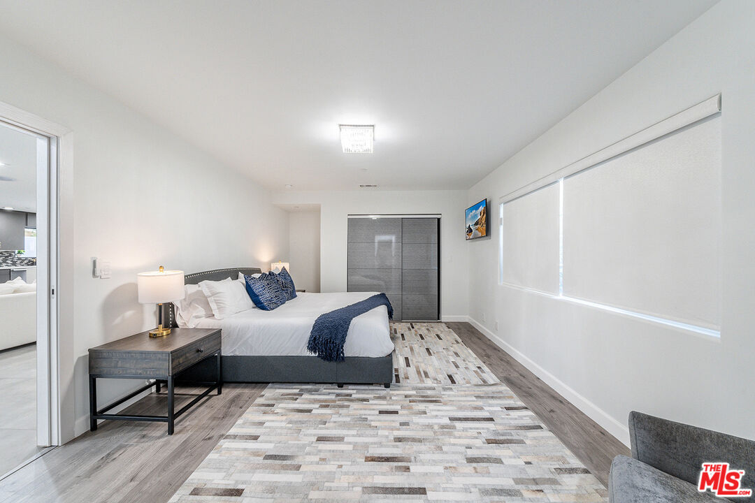 5010 Fulton Avenue Sherman Oaks, CA 91423 - Photo 32 of 55 a bedroom with a bed and wooden floor