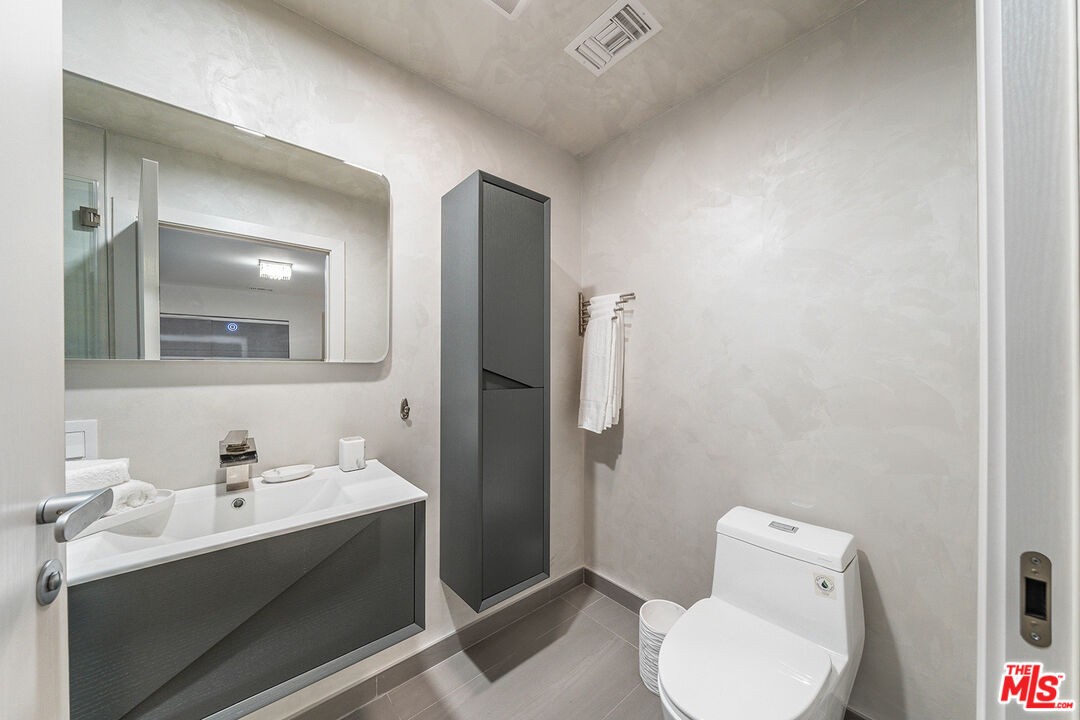 5010 Fulton Avenue Sherman Oaks, CA 91423 - Photo 34 of 55 a bathroom with a toilet sink and mirror