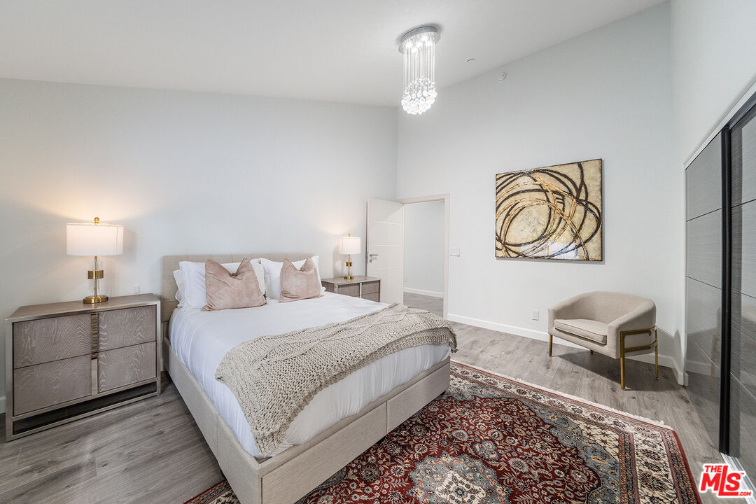5010 Fulton Avenue Sherman Oaks, CA 91423 - Photo 36 of 55 a bedroom with a bed and a chandelier