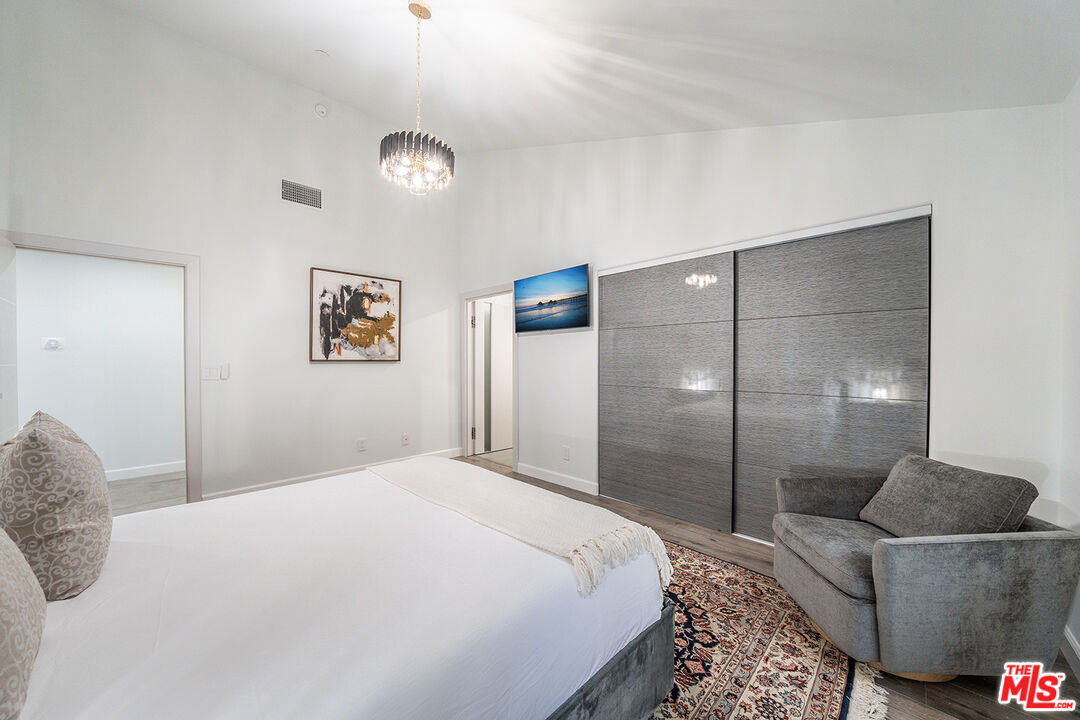5010 Fulton Avenue Sherman Oaks, CA 91423 - Photo 39 of 55 a bedroom with a bed and a chandelier