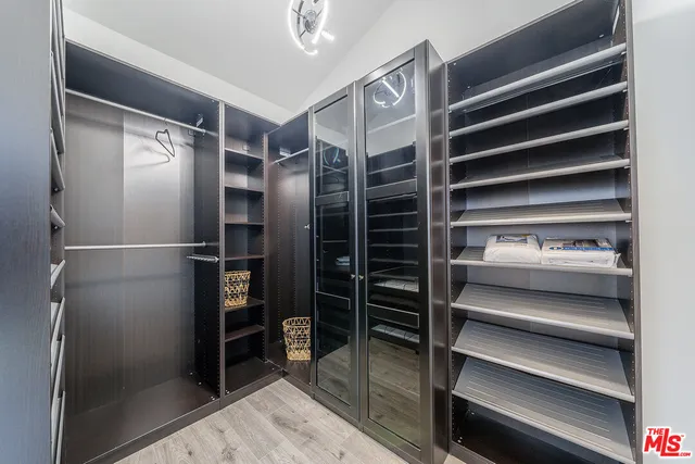 a bedroom with a bed and a mirror