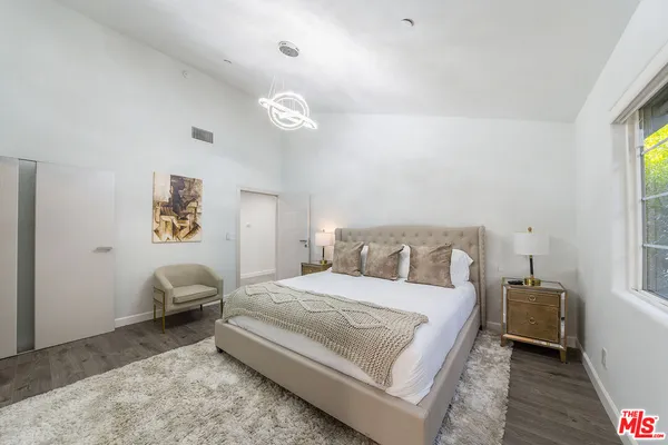 a bed room with a bed and a chair