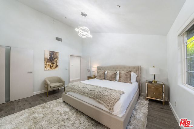 a bed room with a bed and a chair