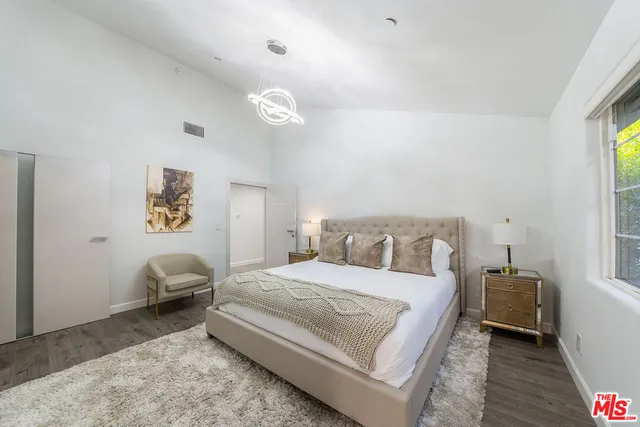 a bed room with a bed and a chair