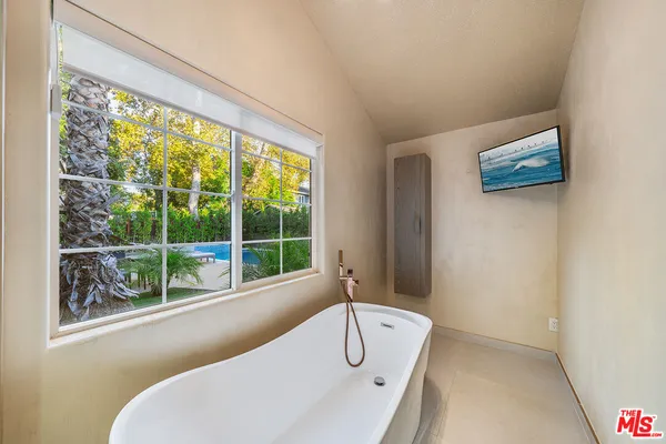 a bathroom with a toilet sink vanity granite and shower