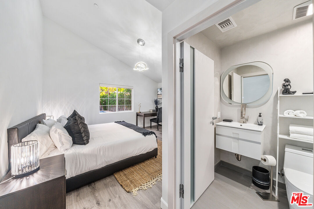 5010 Fulton Avenue Sherman Oaks, CA 91423 - Photo 47 of 55 a bedroom with a bed and a mirror