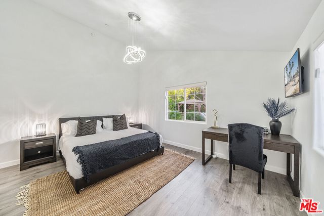 a view of a patio with couches and chairs under an umbrella