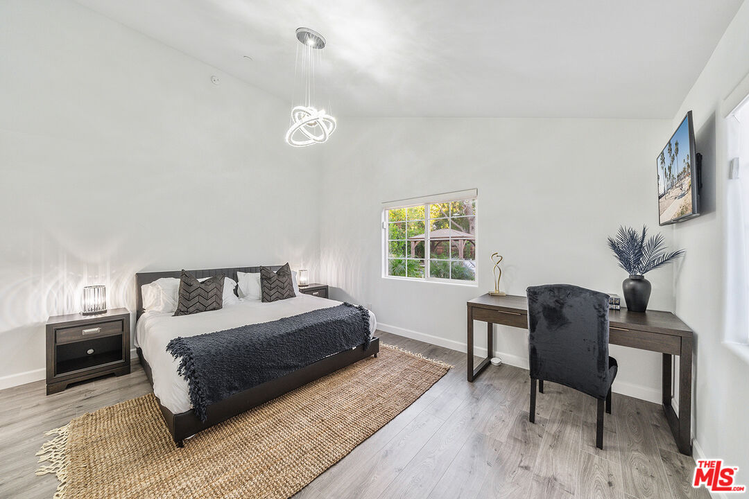 5010 Fulton Avenue Sherman Oaks, CA 91423 - Photo 49 of 55 a bedroom with a bed and a chair