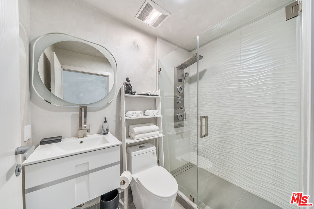 5010 Fulton Avenue Sherman Oaks, CA 91423 - Photo 51 of 55 a bathroom with a toilet sink vanity granite and shower