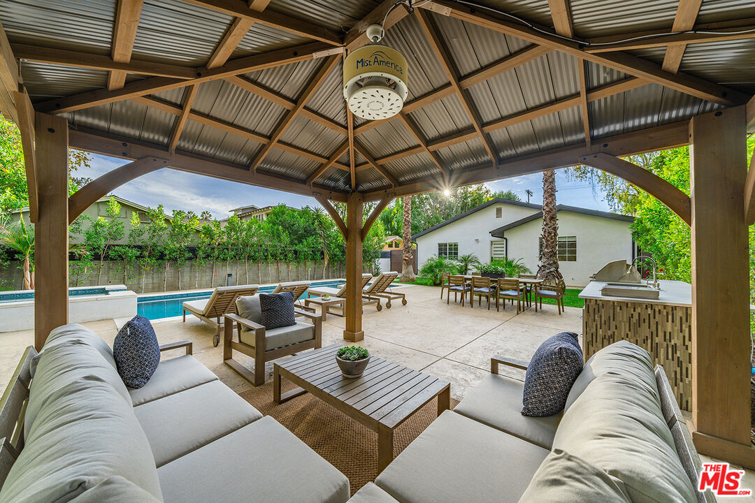 5010 Fulton Avenue Sherman Oaks, CA 91423 - Photo 54 of 55 a view of a patio with couches and chairs under an umbrella