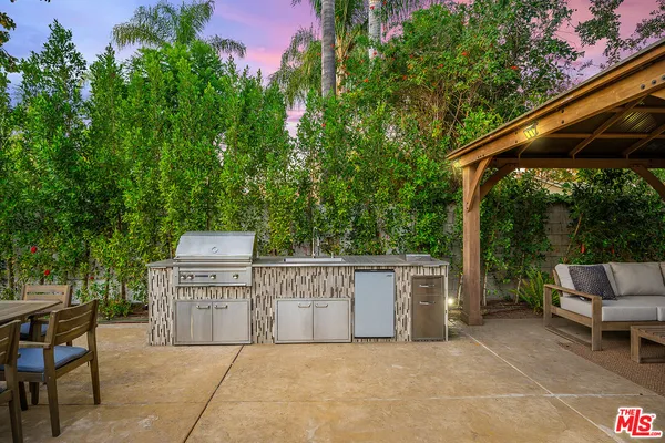 a view of a patio with table and chairs and potted plants