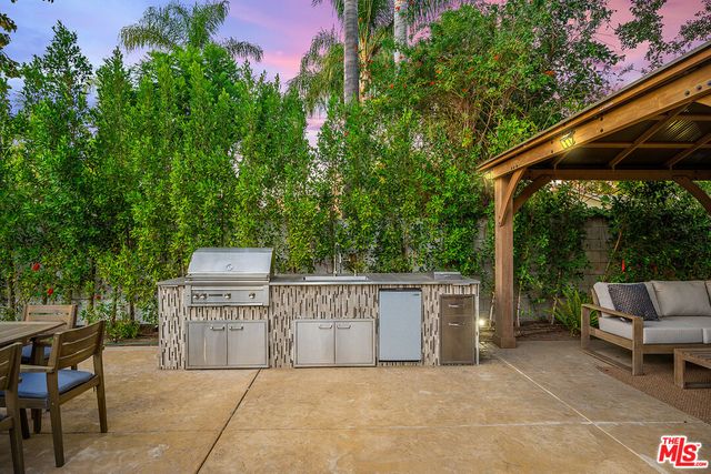 a view of a patio with table and chairs and potted plants