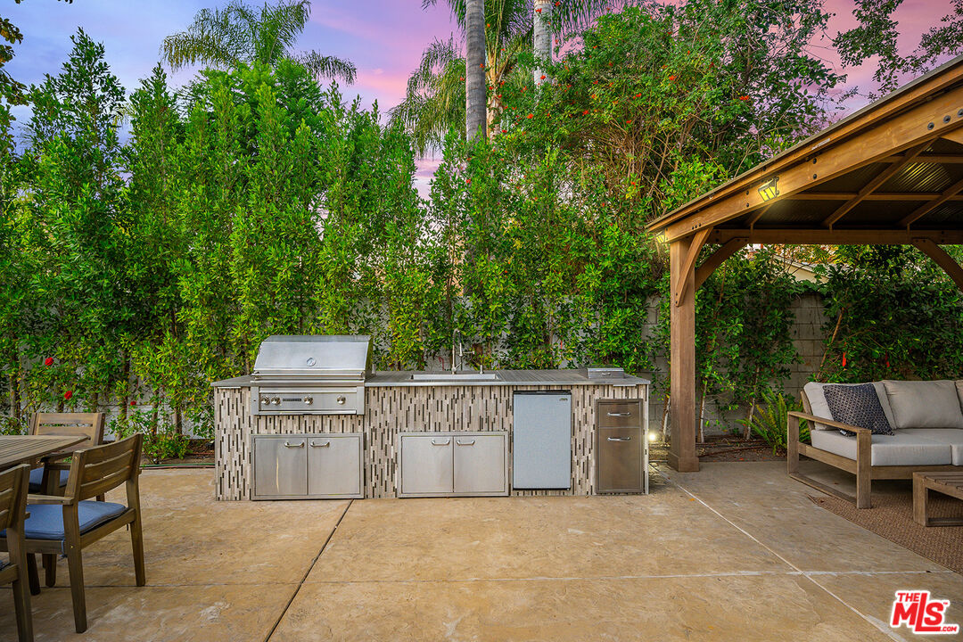 5010 Fulton Avenue Sherman Oaks, CA 91423 - Photo 6 of 55 a view of a patio with table and chairs and potted plants