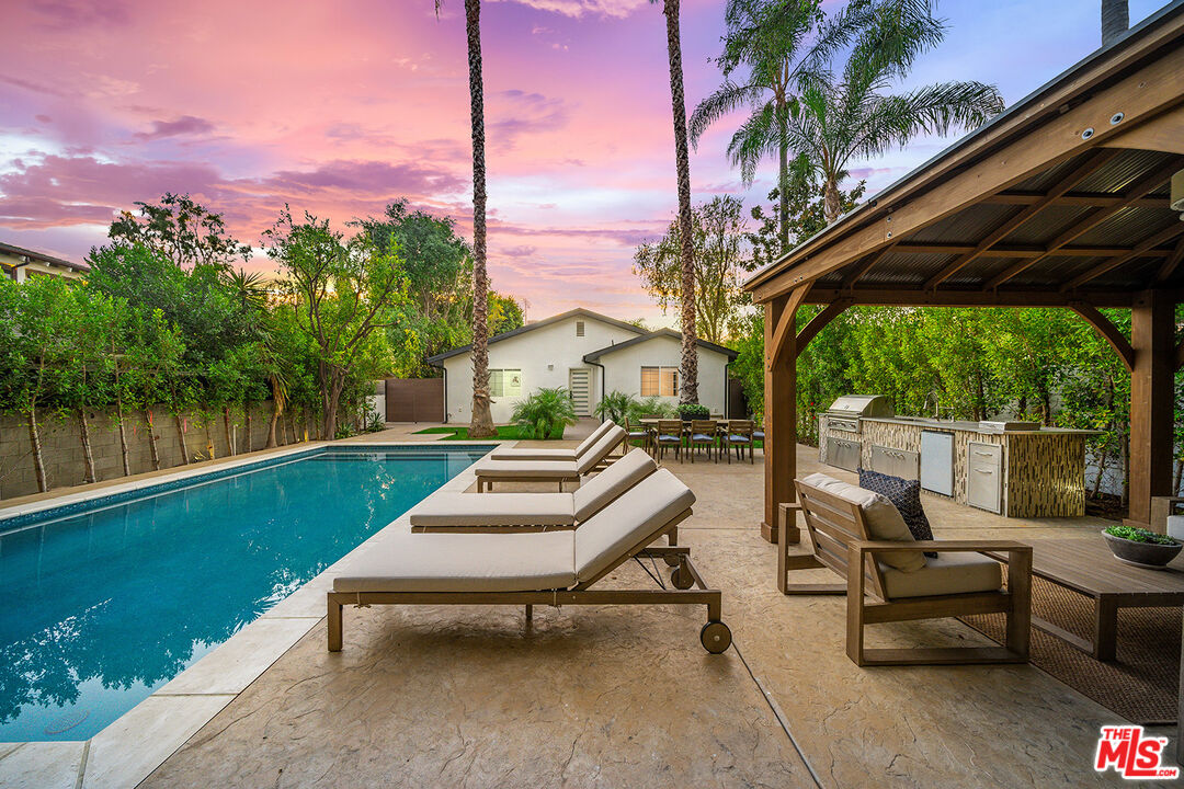5010 Fulton Avenue Sherman Oaks, CA 91423 - Photo 8 of 55 a view of a patio with a table chairs and a swimming pool
