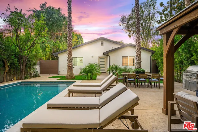 a view of swimming pool with outdoor seating and plants