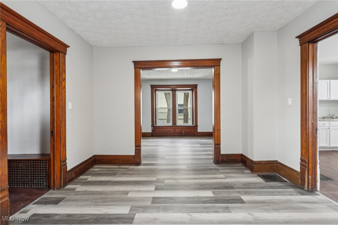 73 East York Street Akron, OH 44310 - Photo 21 of 36 Hall featuring a textured ceiling and light wood-type flooring