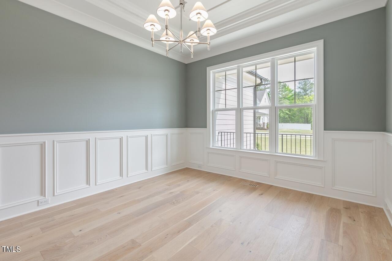 816 Crimson Rdg Trail Fuquay-Varina, NC 27526 - Photo 14 of 42 a view of an empty room with wooden floor and a window