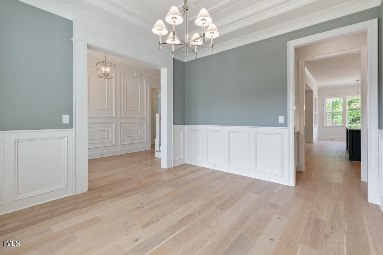 816 Crimson Rdg Trail Fuquay-Varina, NC 27526 - Photo 15 of 42 a view of a hallway with wooden floor and a chandelier