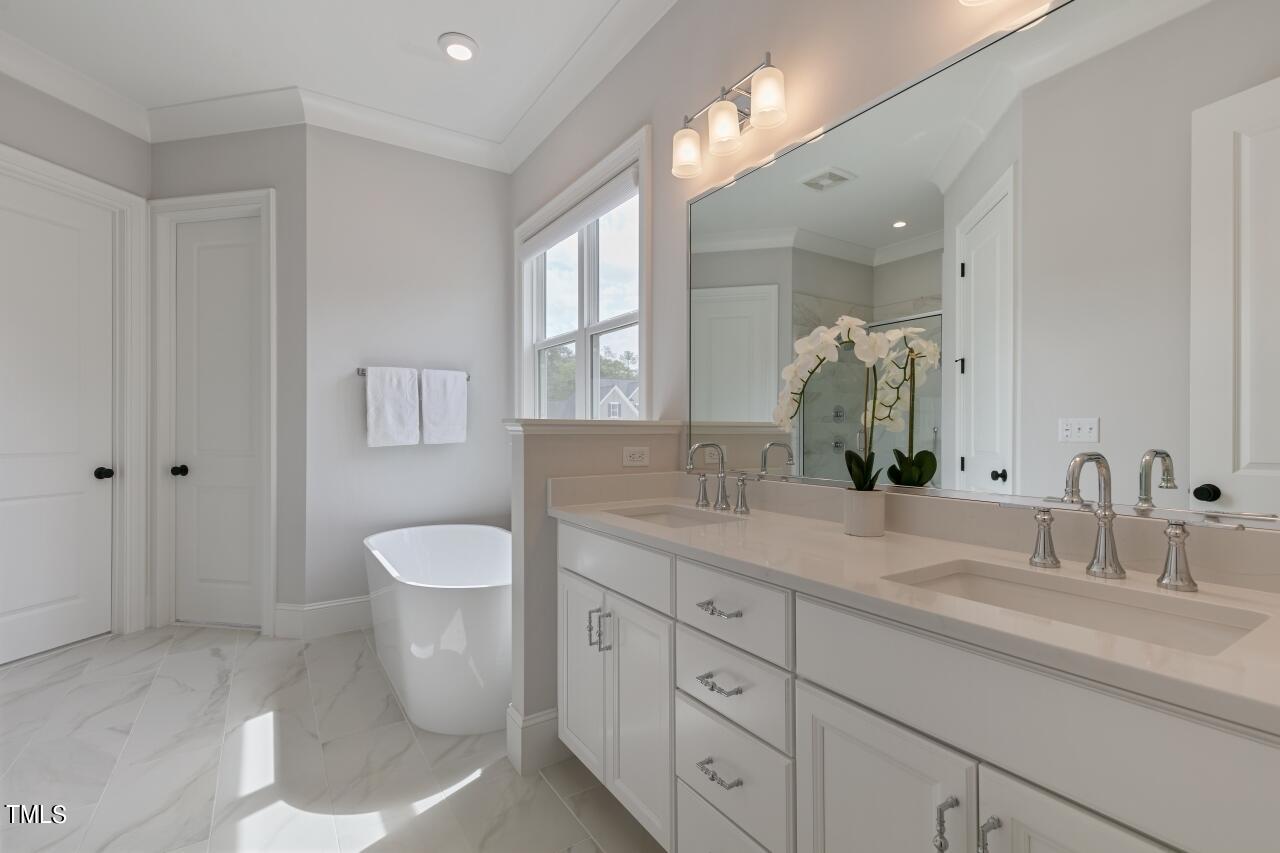 816 Crimson Rdg Trail Fuquay-Varina, NC 27526 - Photo 18 of 42 a spacious bathroom with a toilet sink and mirror