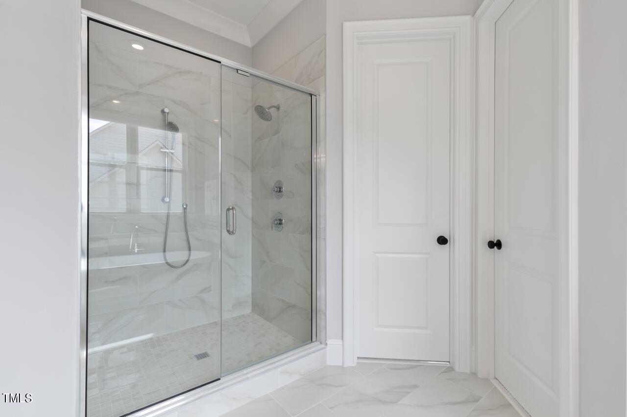 816 Crimson Rdg Trail Fuquay-Varina, NC 27526 - Photo 19 of 42 a bathroom with a glass shower door