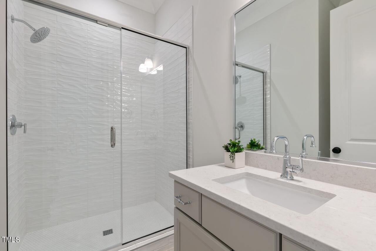 816 Crimson Rdg Trail Fuquay-Varina, NC 27526 - Photo 23 of 42 a bathroom with a shower sink and mirror