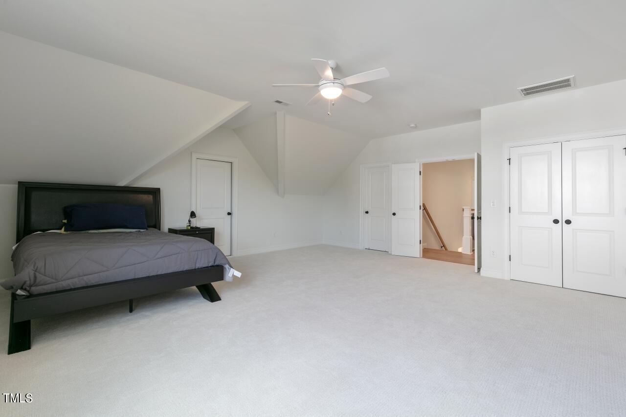 816 Crimson Rdg Trail Fuquay-Varina, NC 27526 - Photo 29 of 42 a bedroom with a bed and cabinets