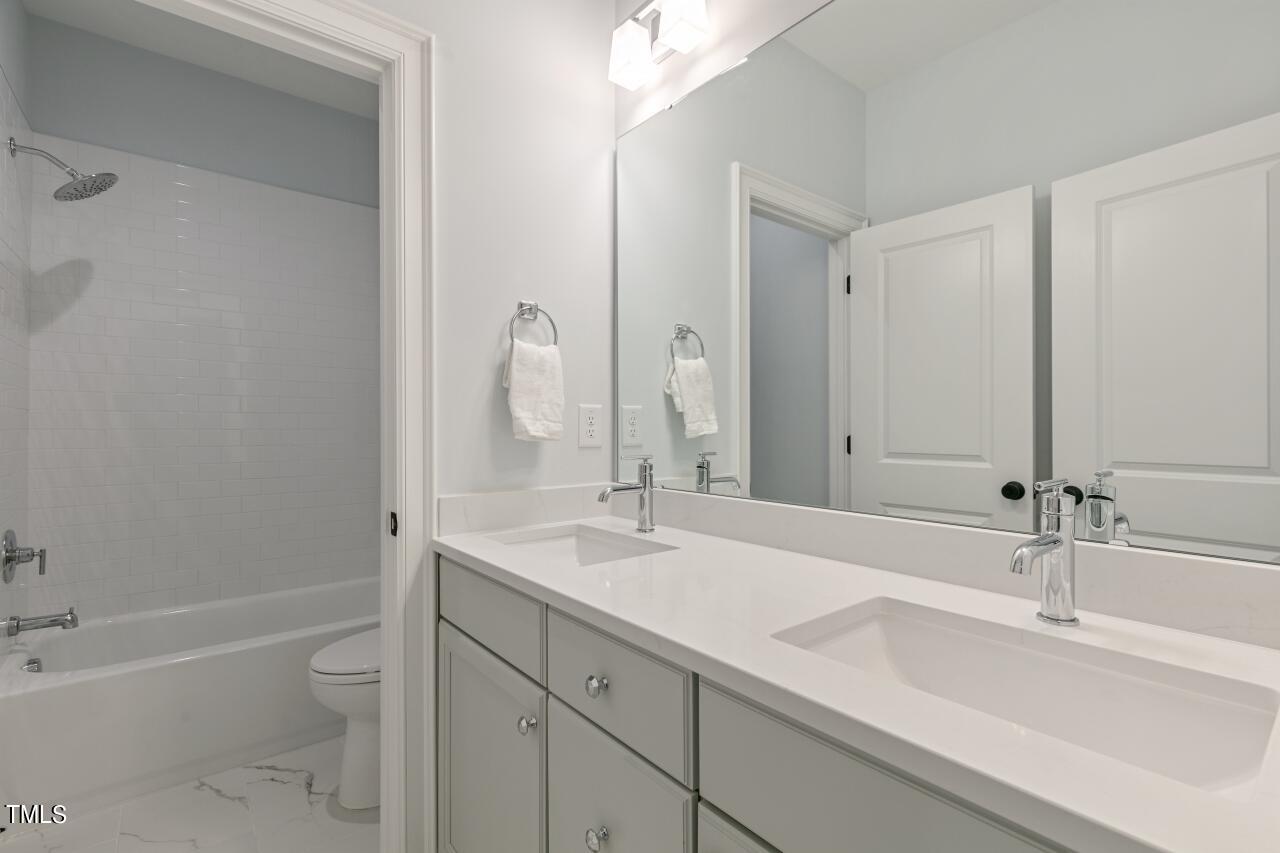 816 Crimson Rdg Trail Fuquay-Varina, NC 27526 - Photo 30 of 42 a bathroom with a sink double vanity granite tub and a mirror