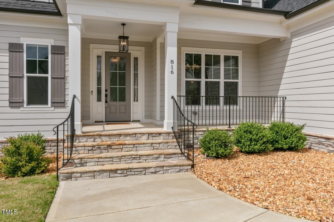 816 Crimson Rdg Trail Fuquay-Varina, NC 27526 - Photo 3 of 42 a front view of a house with a garden