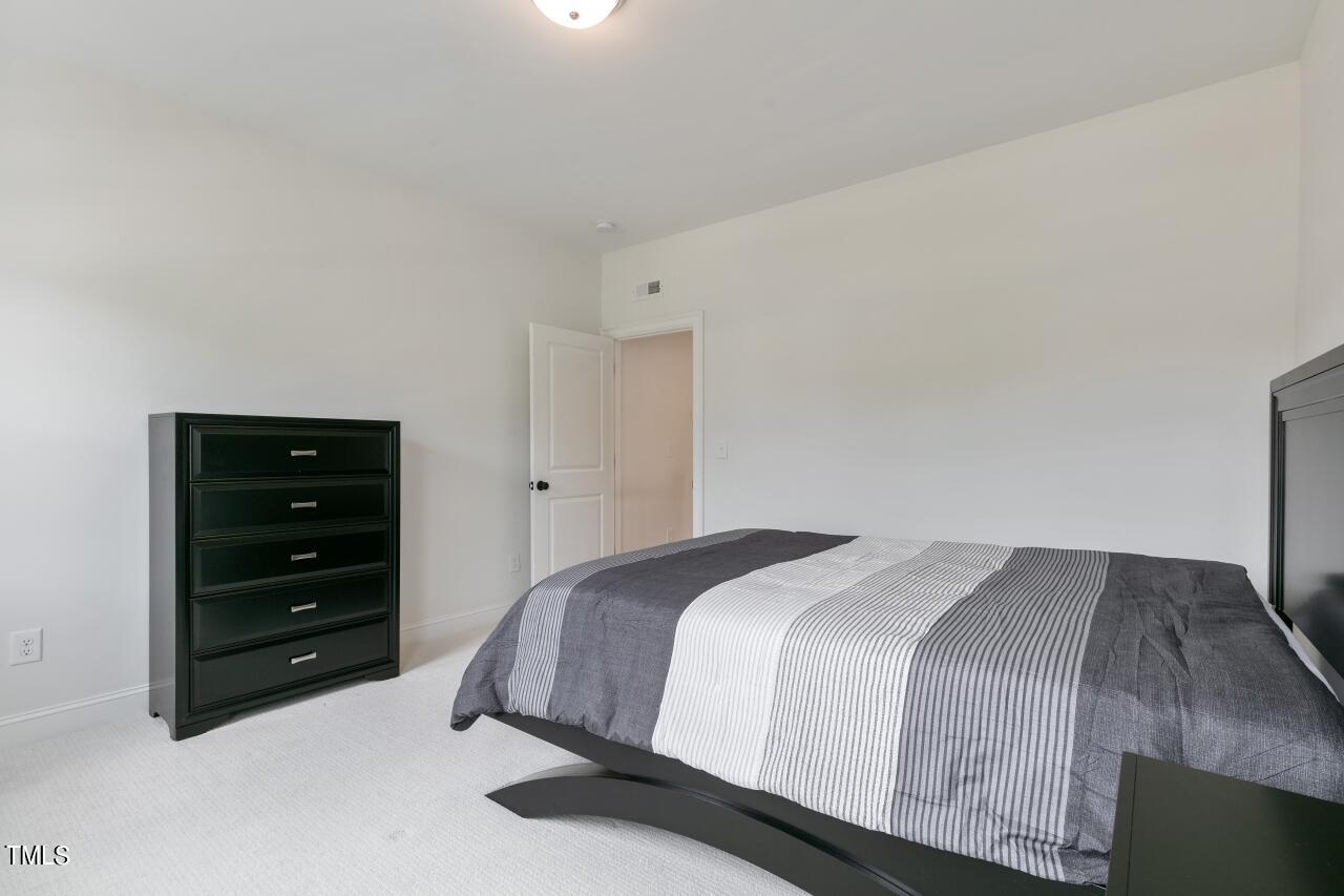 816 Crimson Rdg Trail Fuquay-Varina, NC 27526 - Photo 34 of 42 a bedroom with a bed and a dresser