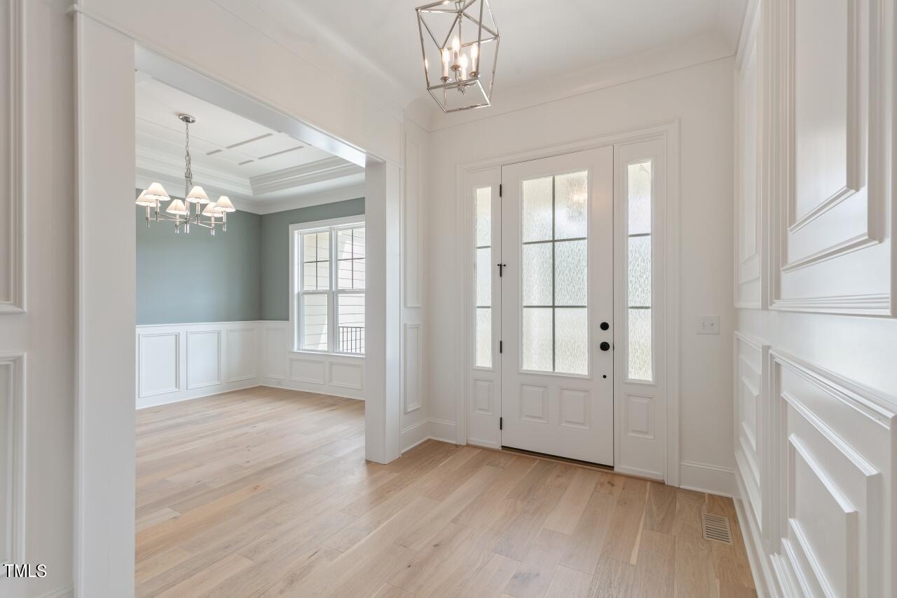 816 Crimson Rdg Trail Fuquay-Varina, NC 27526 - Photo 4 of 42 a view of an empty room with wooden floor and a window