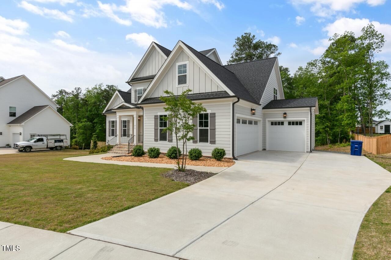816 Crimson Rdg Trail Fuquay-Varina, NC 27526 - Photo 42 of 42 a front view of a house with a garden and tree