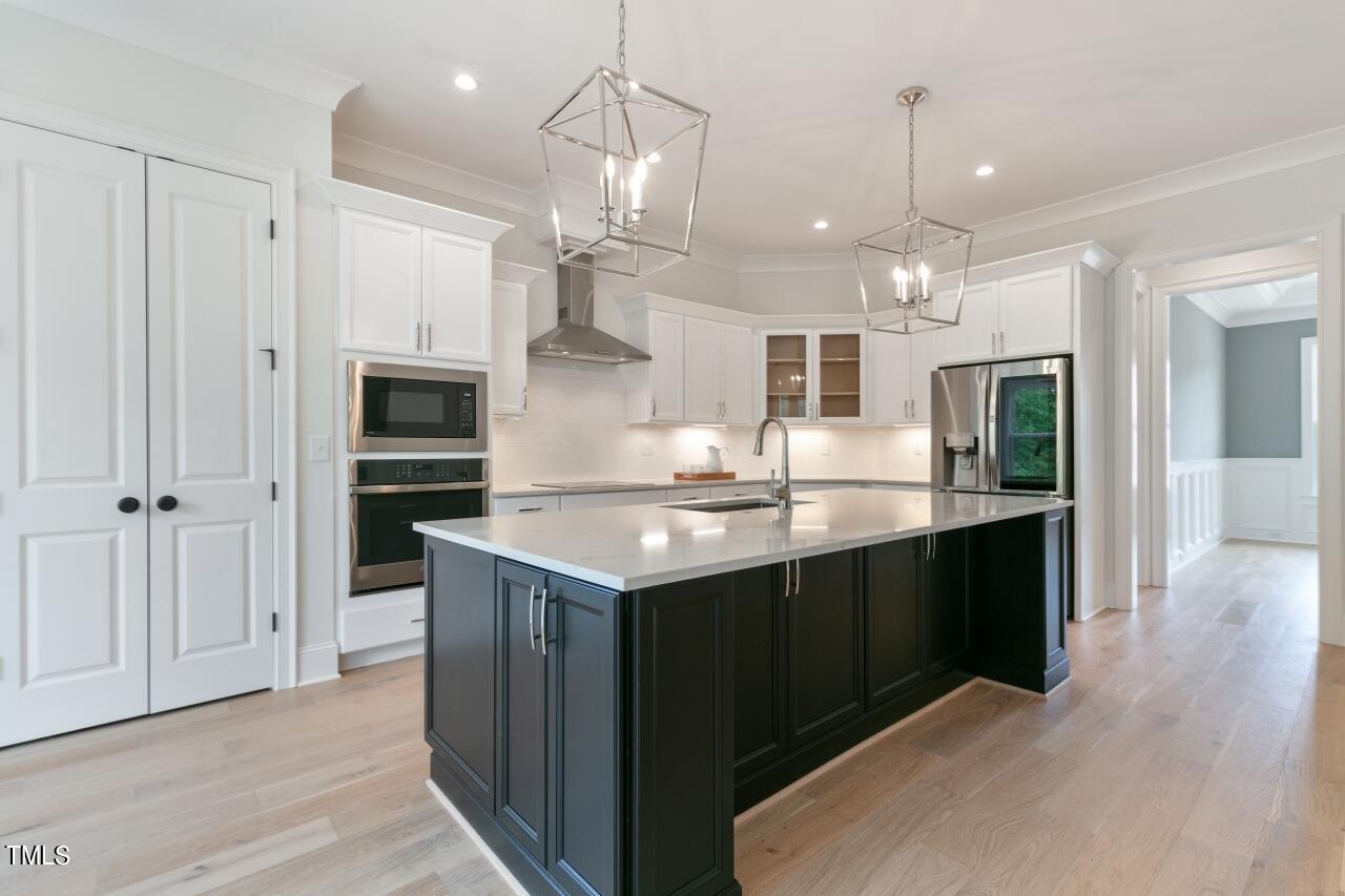 816 Crimson Rdg Trail Fuquay-Varina, NC 27526 - Photo 7 of 42 a kitchen with kitchen island a sink stainless steel appliances and cabinets