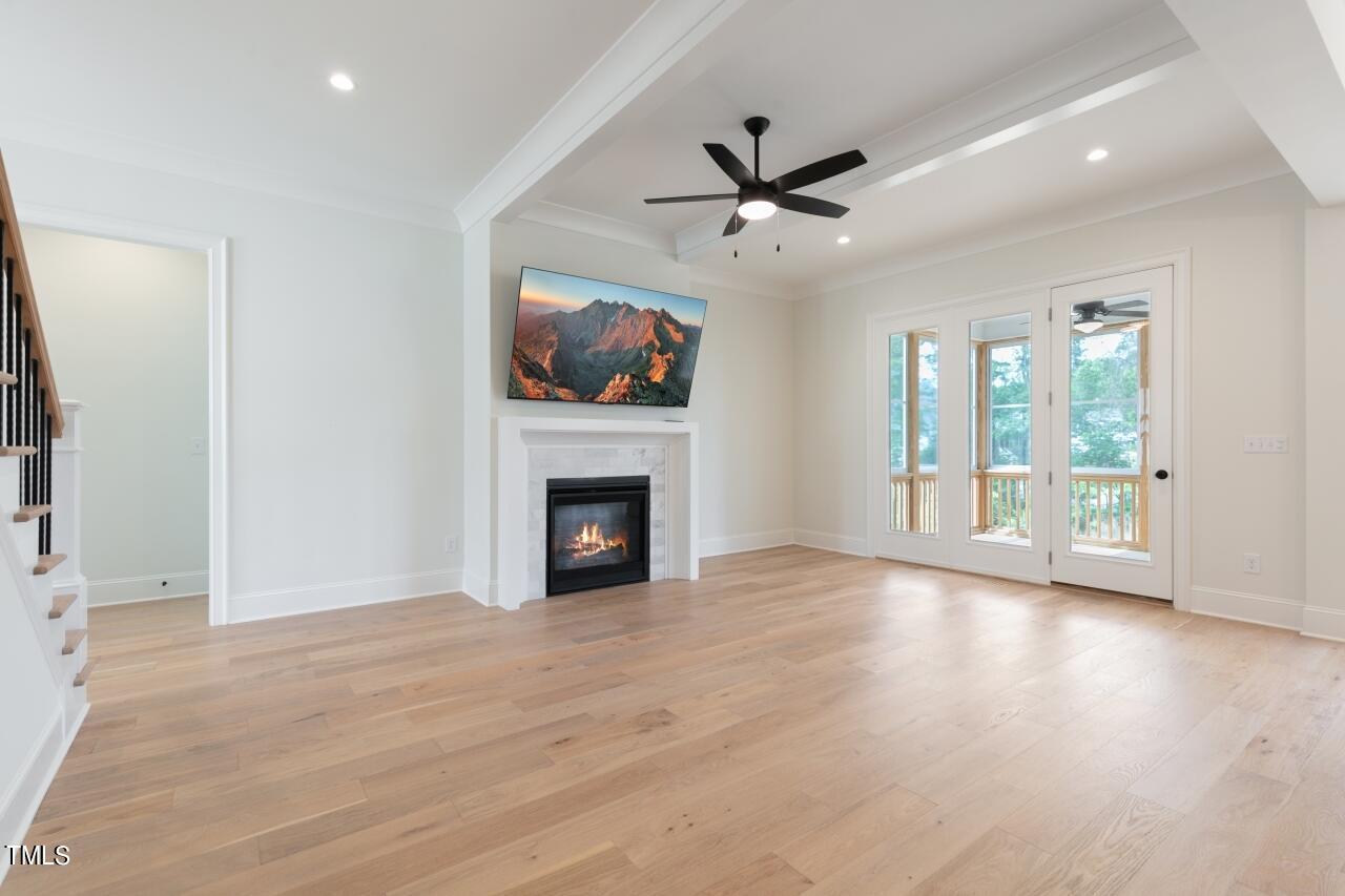 816 Crimson Rdg Trail Fuquay-Varina, NC 27526 - Photo 10 of 42 a view of an empty room with a fireplace and a window