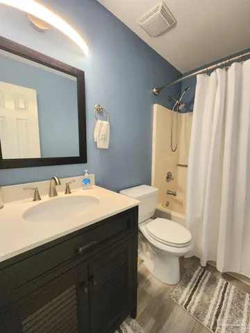 a bathroom with a double vanity sink mirror and toilet