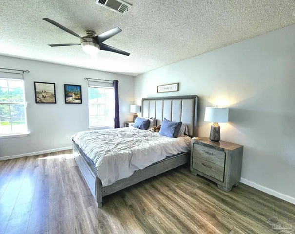 a bedroom with a bed and a night stand