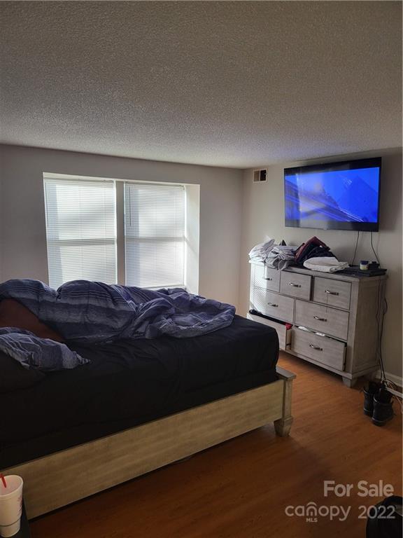 9405 Old Concord Road, Unit D Charlotte, NC 28213 - Photo 11 of 17 a bedroom with a bed and dresser