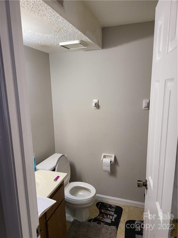 9405 Old Concord Road, Unit D Charlotte, NC 28213 - Photo 12 of 17 a white toilet sitting next to a white sink and vanity